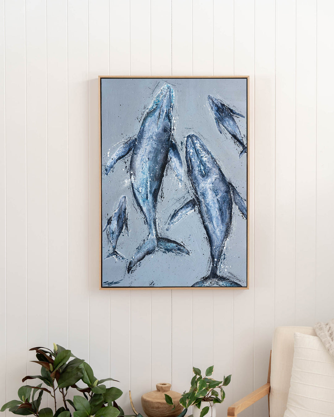 Raise Them on Rhythm and Blues – humpback whales, framed canvas in oak float frame, styled in a hallway