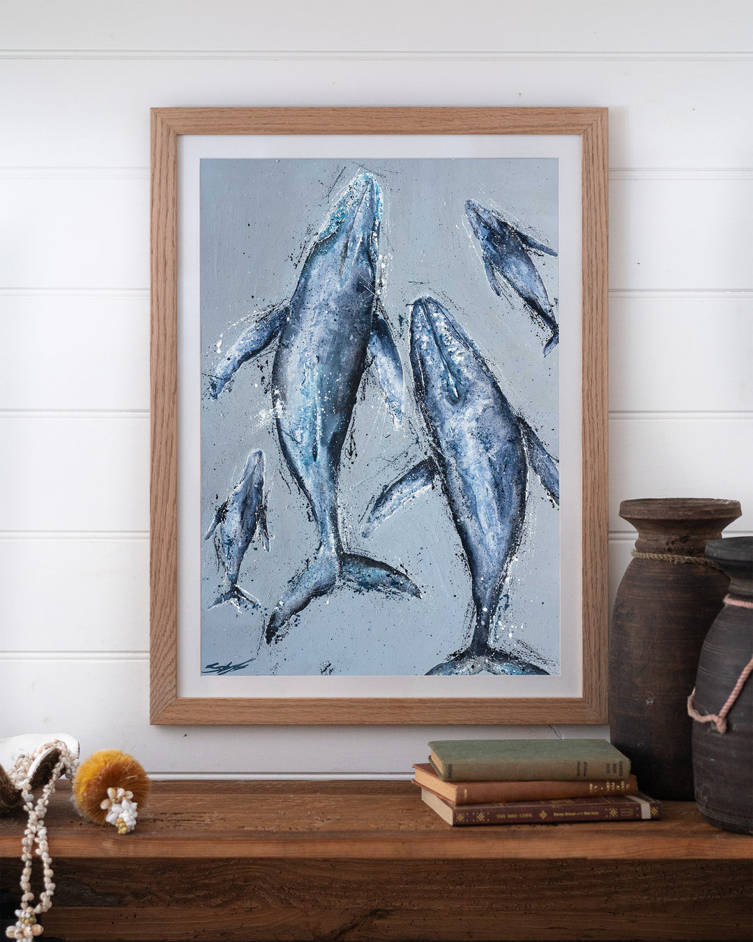 Raise Them on Rhythm and Blues – humpback whales, framed paper print in oak frame, styled on a timber shelf