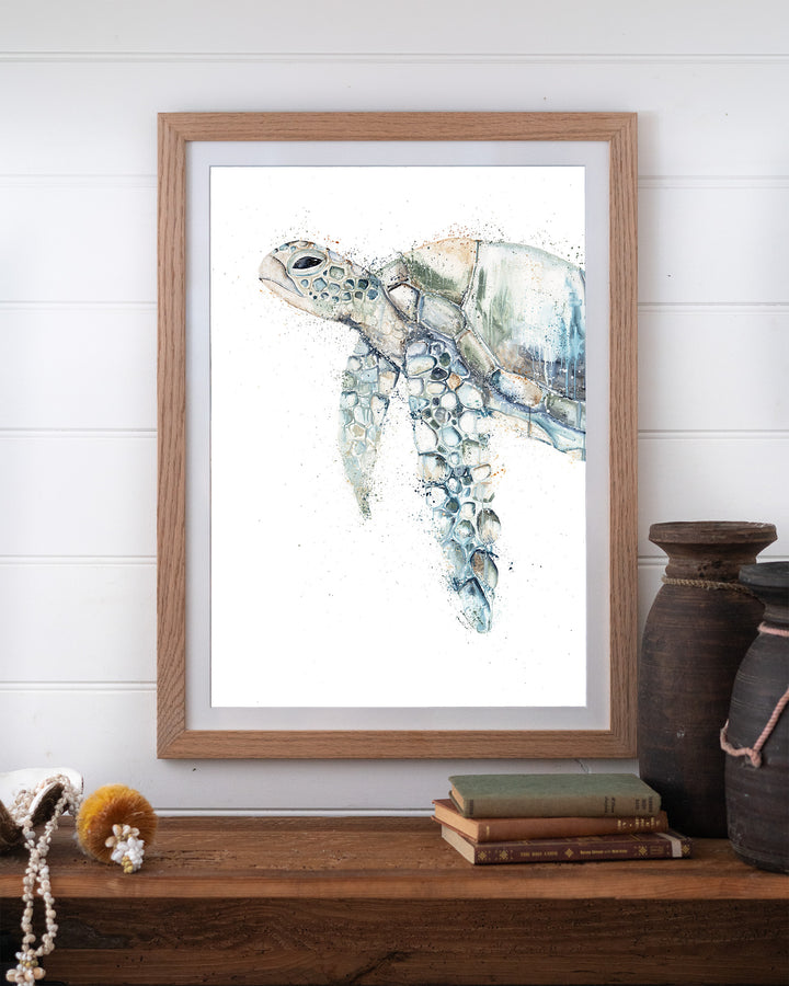 Renegade green sea turtle fine art print by Stephanie Elizabeth, framed paper print in an oak frame on a shelf