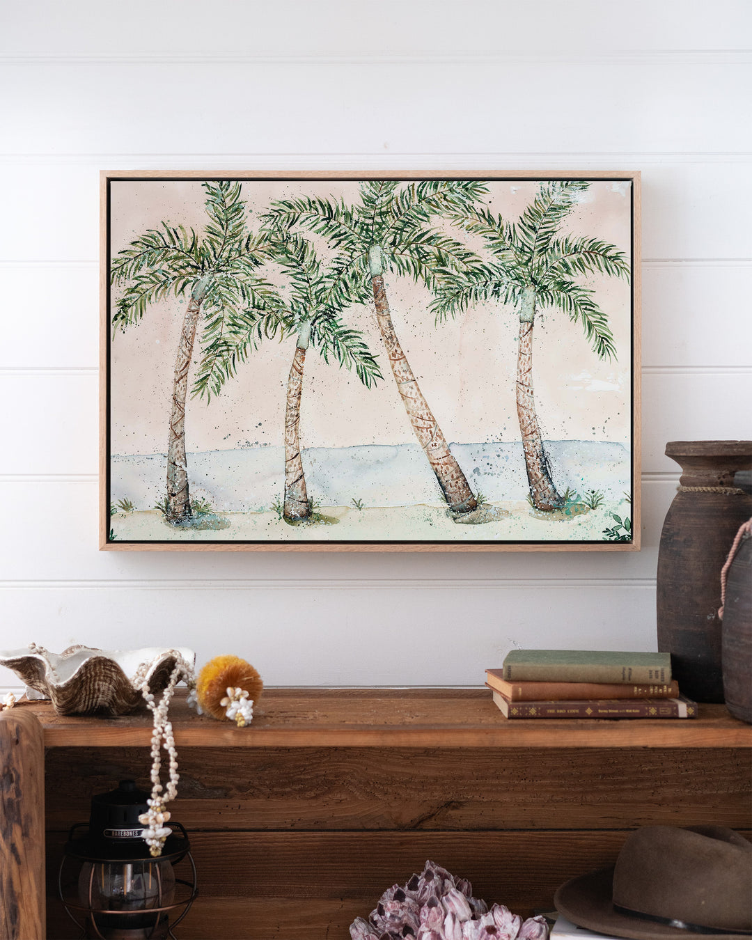 Rex Smeal Serenade – palm trees at Rex Smeal Park, Port Douglas, framed canvas in oak float frame, styled above a timber console