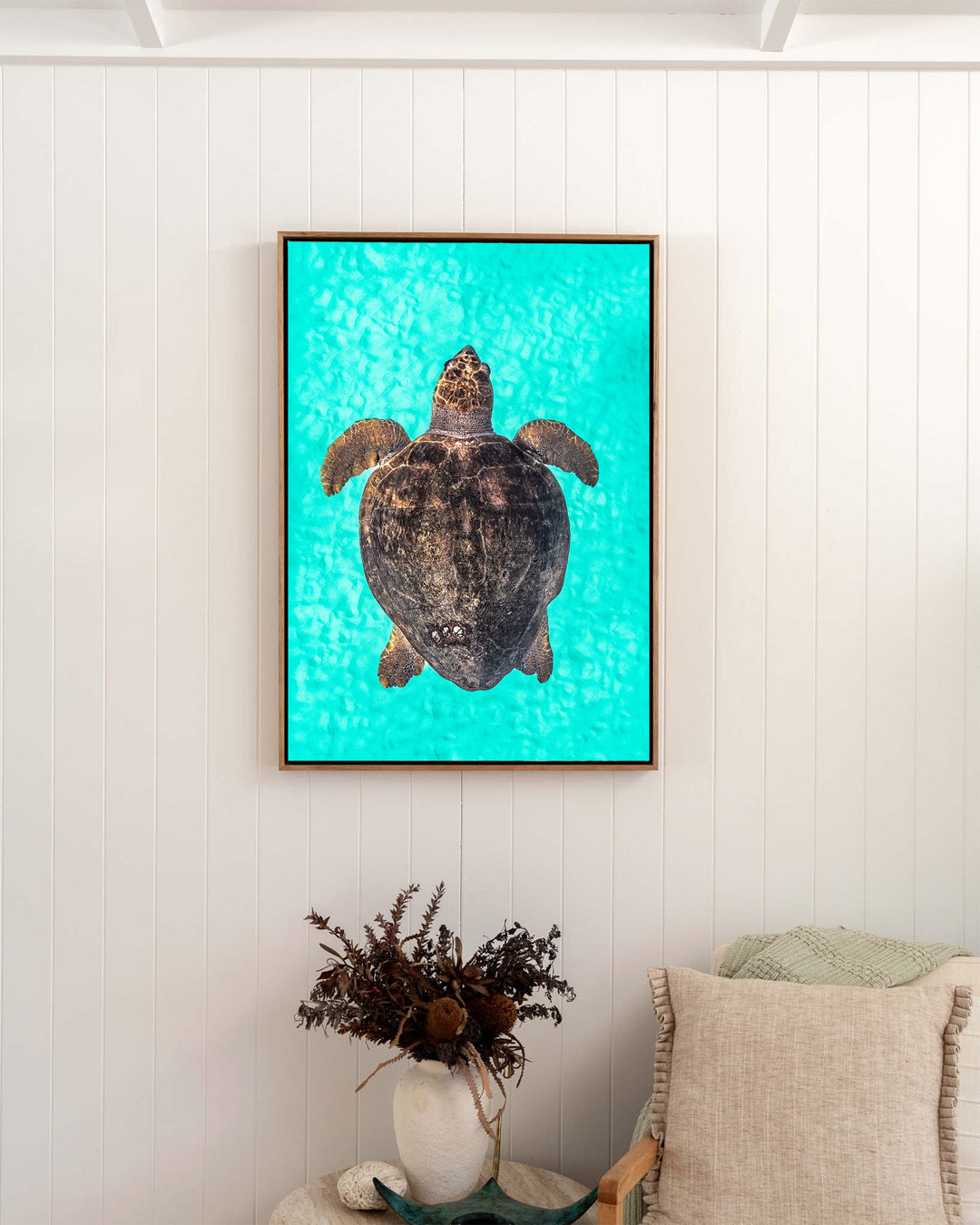 Rust and Sand – Loggerhead Turtle, Underwater Photography by David Lloyd, framed canvas print in oak float frame, styled in a bedroom setting