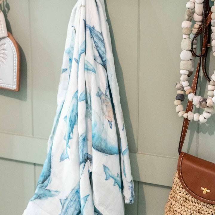 sea life baby swaddle featuring whale, turtle and sharks - hanging on wall close up