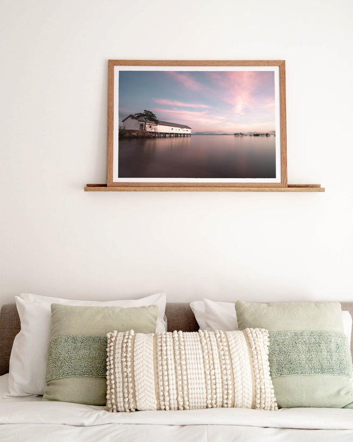 Serenity at Sugar – Port Douglas Sugar Wharf, Landscape Photography by David Lloyd, framed paper print in oak frame, styled in a bedroom setting