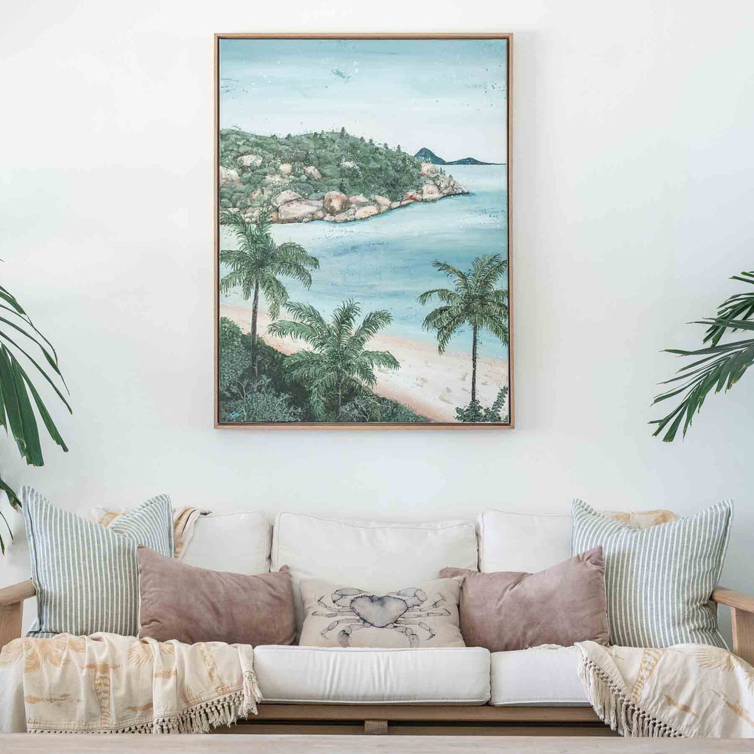 She Calls Me Back – coastal landscape artwork featuring palm trees, beach and turquoise water styled above sofa in a light tropical interior | Original Artwork
