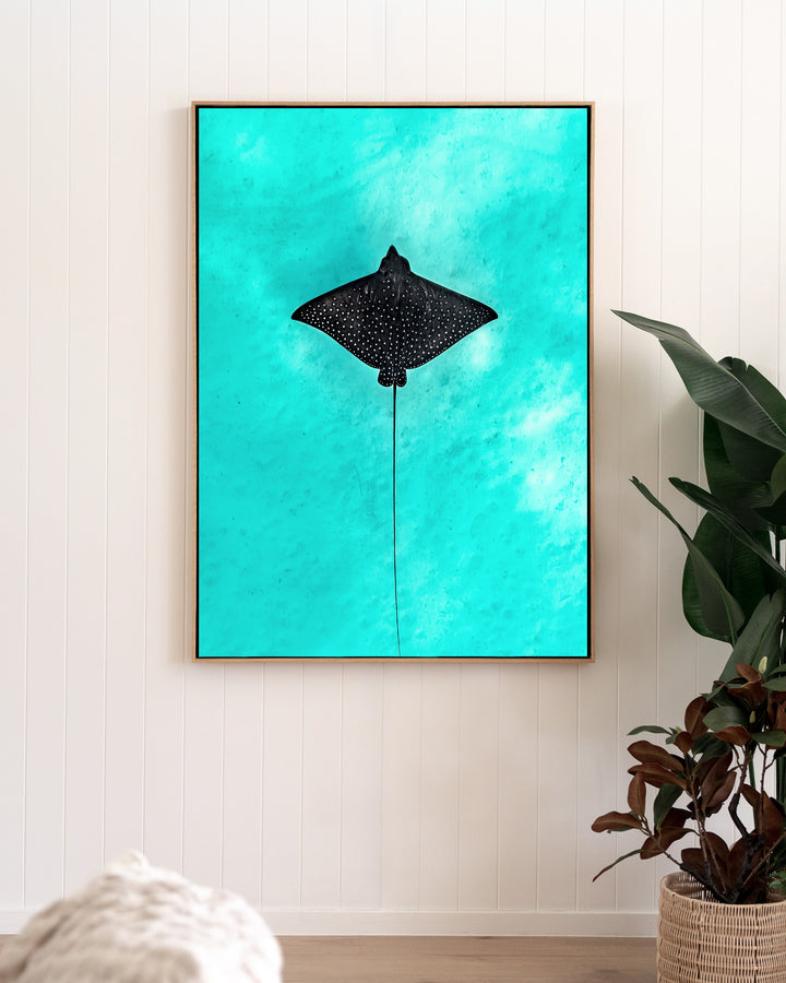 Silent Flight – Eagle Ray, Underwater Photography by David Lloyd, framed canvas print in oak float frame, styled in a living room setting