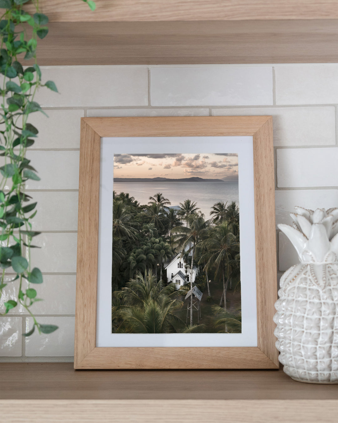 So Easy To Fall In Love – St Mary’s Chapel, Coastal Photography by David Lloyd, framed paper print in oak frame, styled in a kitchen shelf setting