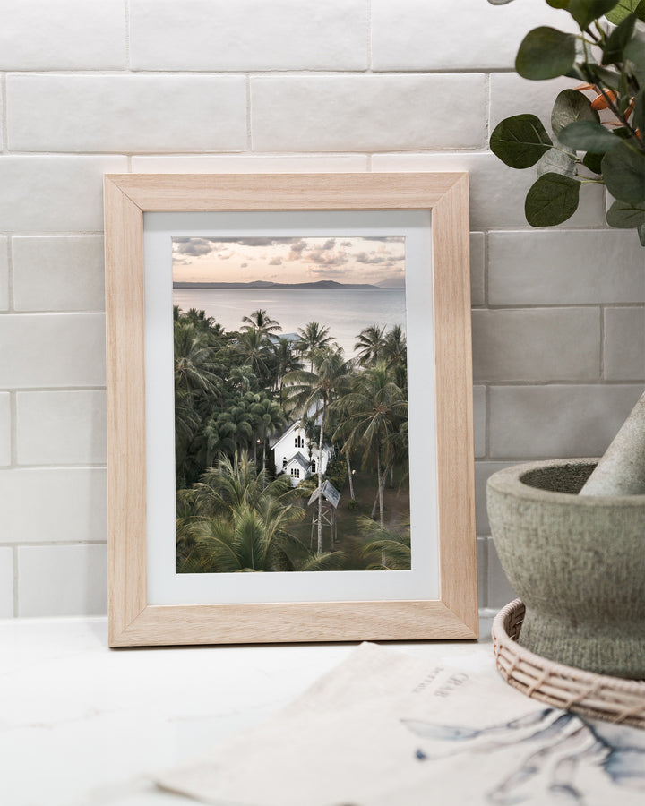 So Easy To Fall In Love – St Mary’s Chapel, Coastal Photography by David Lloyd, framed paper print in oak frame, styled in a kitchen bench setting