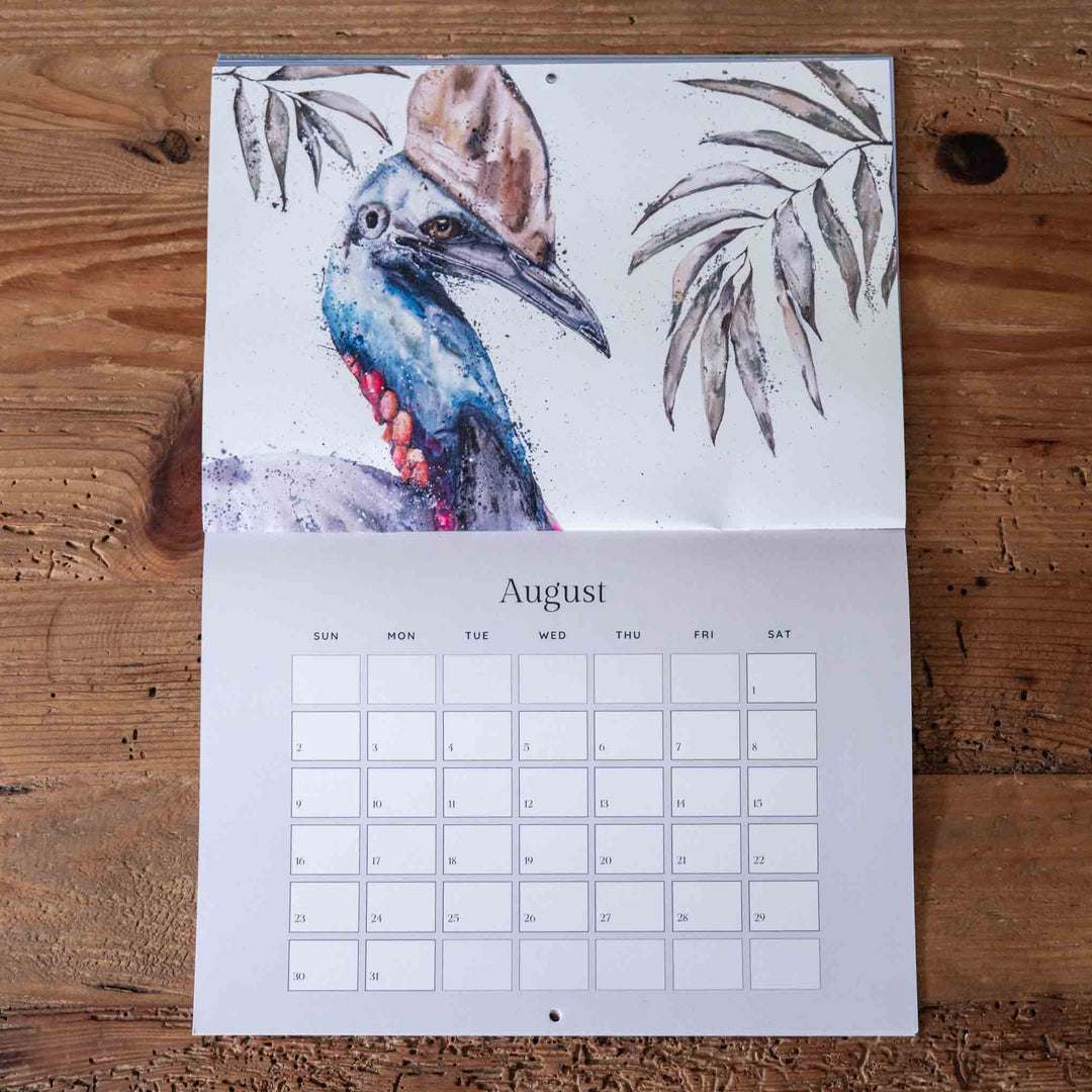 Calendar with a bird illustration on a wooden surface
