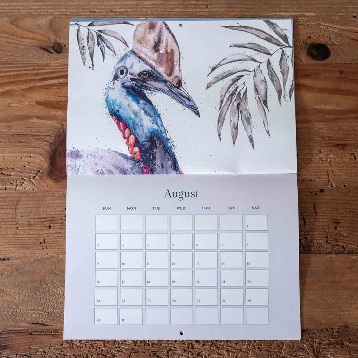 Calendar with a bird illustration on a wooden surface