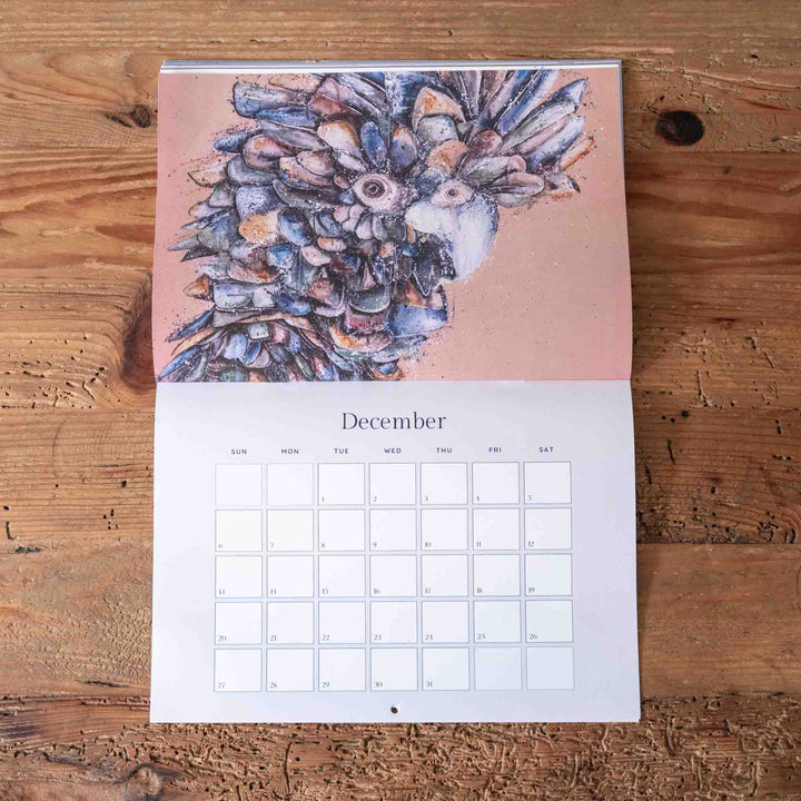 Calendar for December with a floral design on a wooden surface