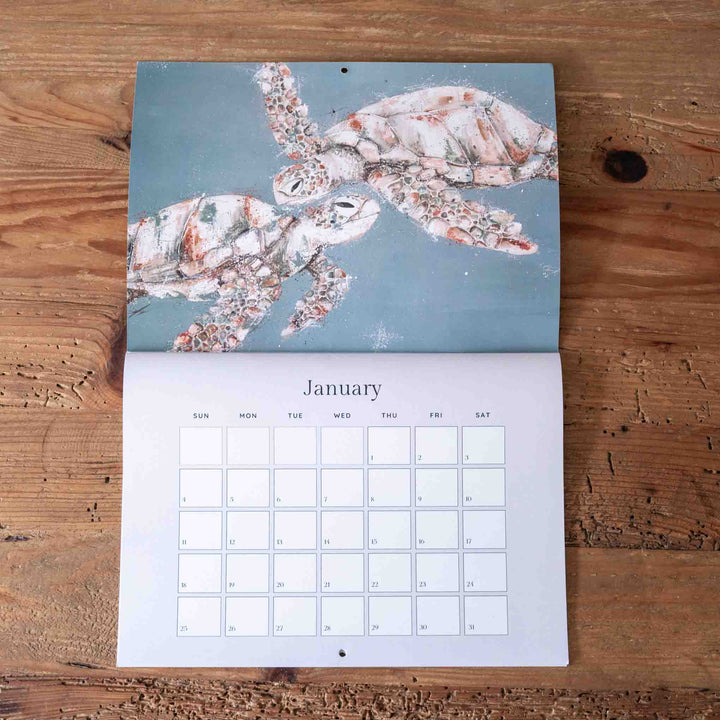 Calendar with a turtle design on the cover, displayed on a wooden surface.