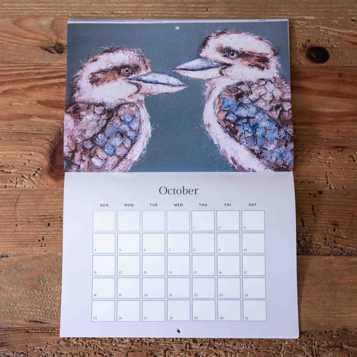 Calendar with kookaburra illustration on a wooden surface