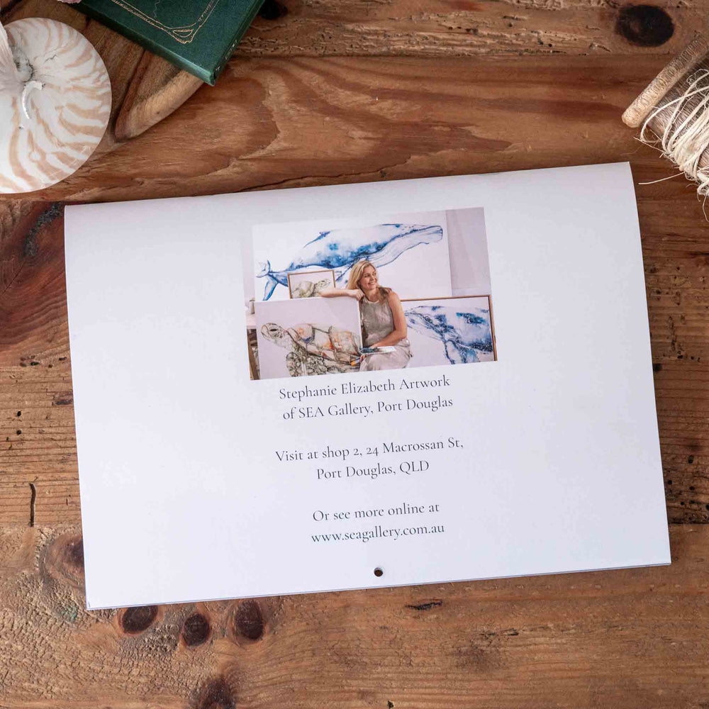 Calendar with artwork on a wooden surface