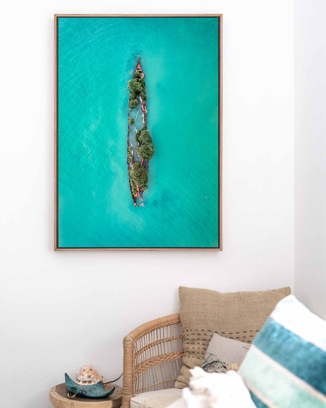 Sunken Solitude – Magnetic Island Shipwreck, Aerial Photography by David Lloyd, framed canvas print in oak float frame, styled in a coastal lounge setting