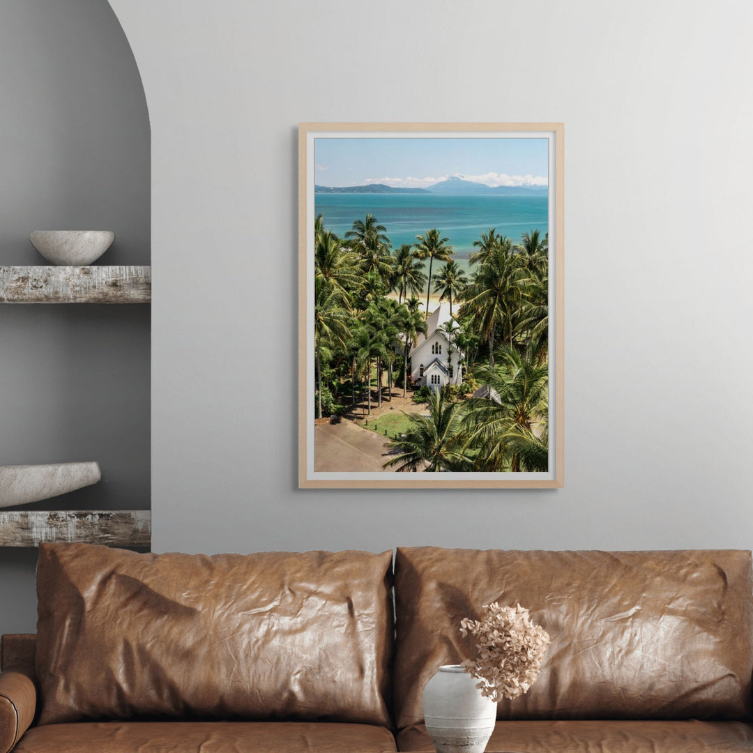 The Art of Loving – bright coastal photograph of St Mary’s Chapel in Port Douglas surrounded by tropical palm trees and ocean backdrop | Framed Paper Print