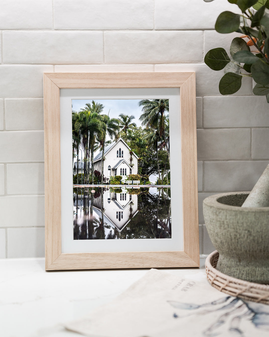 This Too Shall Pass – St Mary’s By The Sea, Landscape Photography by David Lloyd, framed paper print in oak frame, styled in a kitchen bench setting
