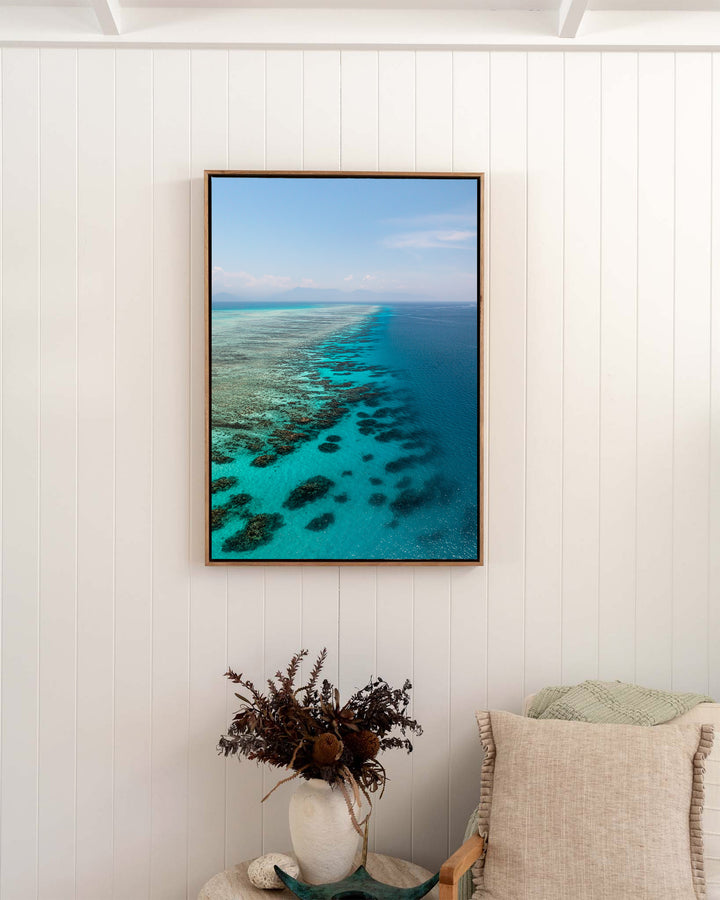 Tip of the Tongue – Tongue Reef, Aerial Photography by David Lloyd, framed canvas print in oak float frame, styled in a bedroom setting