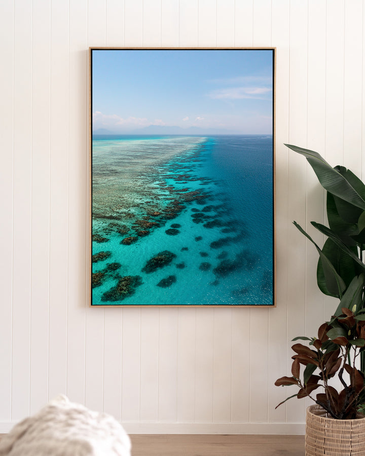 Tip of the Tongue – Tongue Reef, Aerial Photography by David Lloyd, framed canvas print in oak float frame, styled in a living room setting