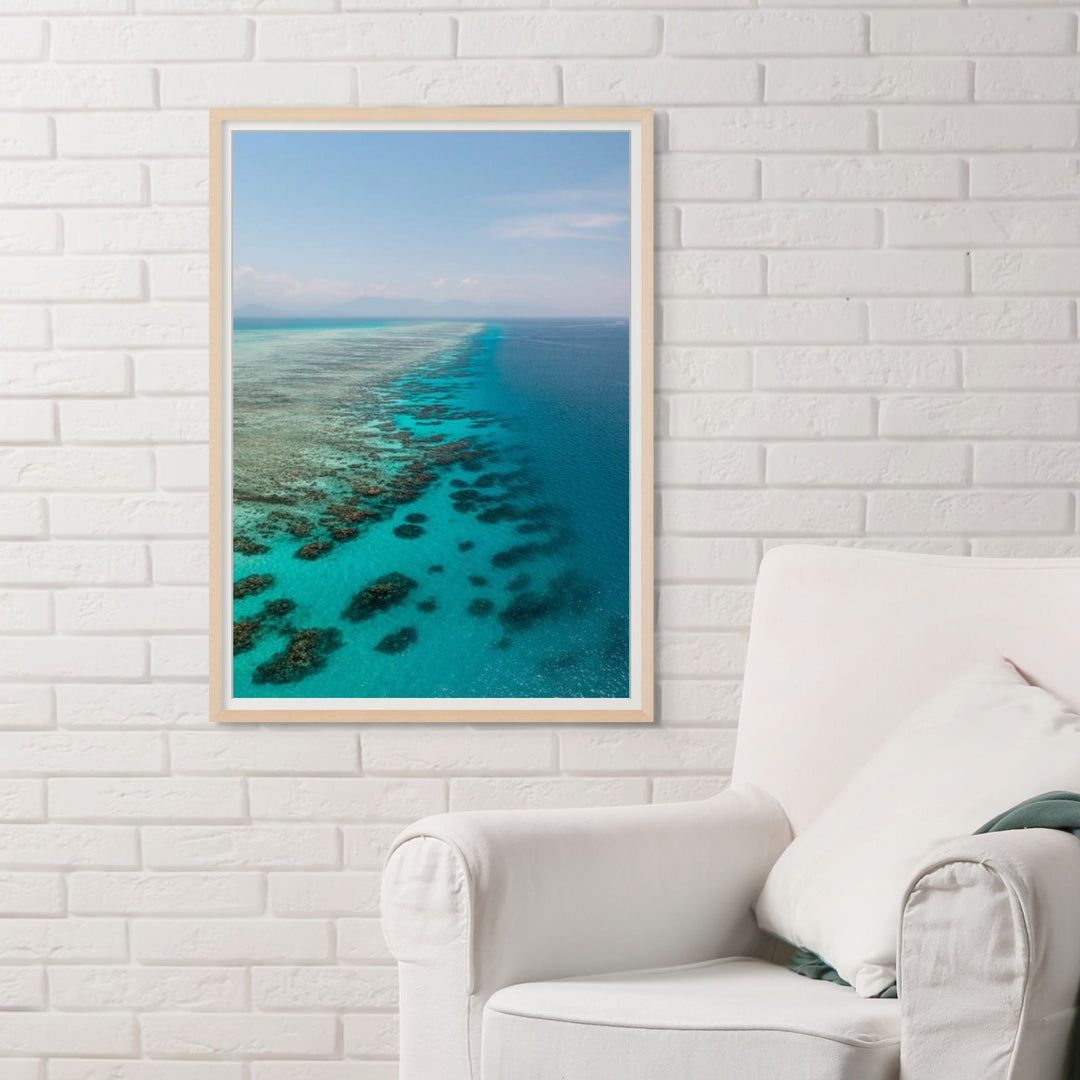 Tip of the Tongue – Aerial view of Tongue Reef with vibrant blue waters, coral bommies, and horizon blending into the mountains | Framed Paper Print