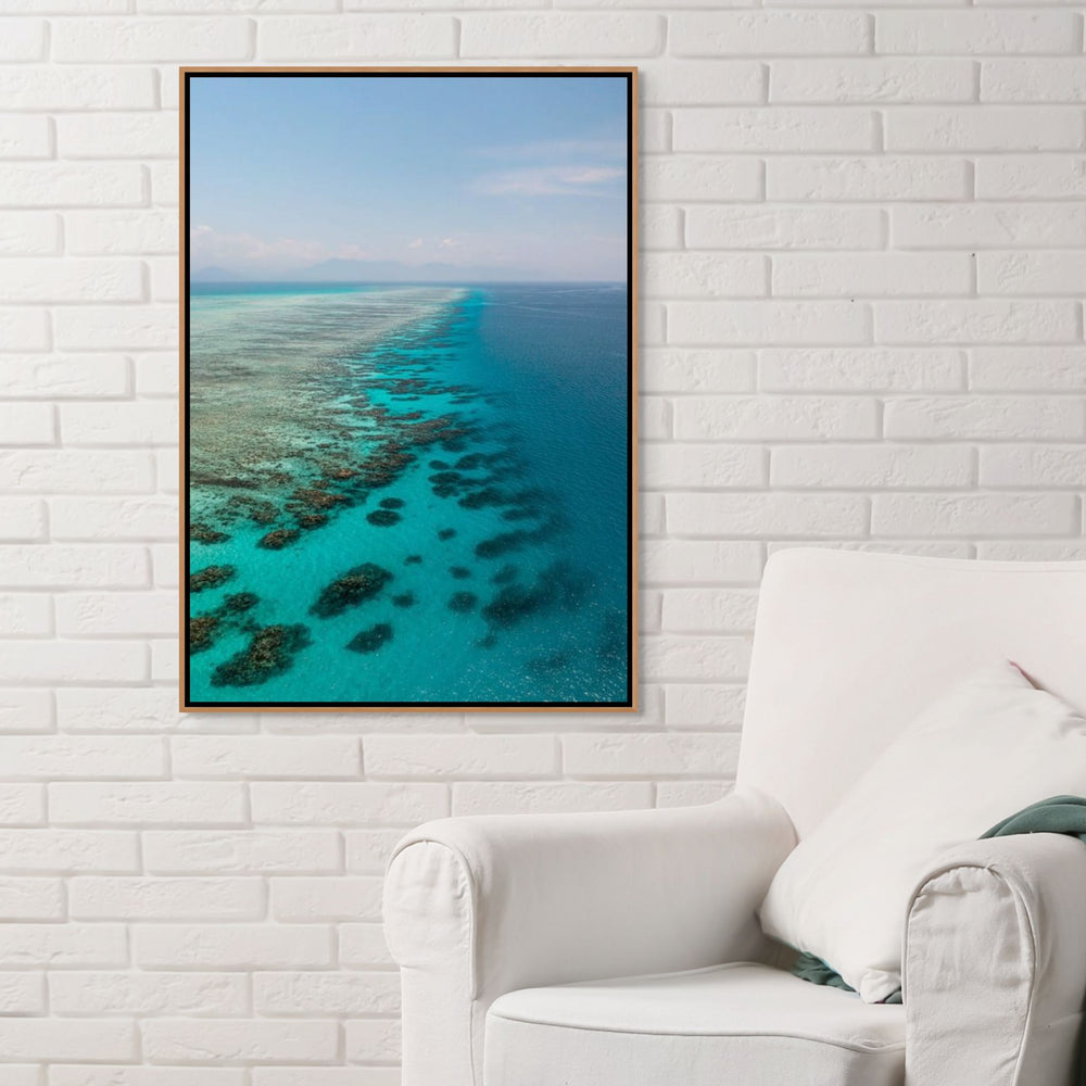 Tip of the Tongue – Aerial view of Tongue Reef with vibrant blue waters, coral bommies, and horizon blending into the mountains | Shadow Box Canvas Print