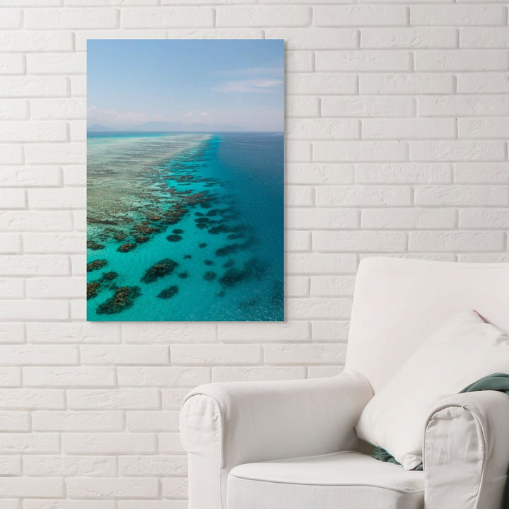 Tip of the Tongue – Aerial view of Tongue Reef with vibrant blue waters, coral bommies, and horizon blending into the mountains | Stretched Canvas Print