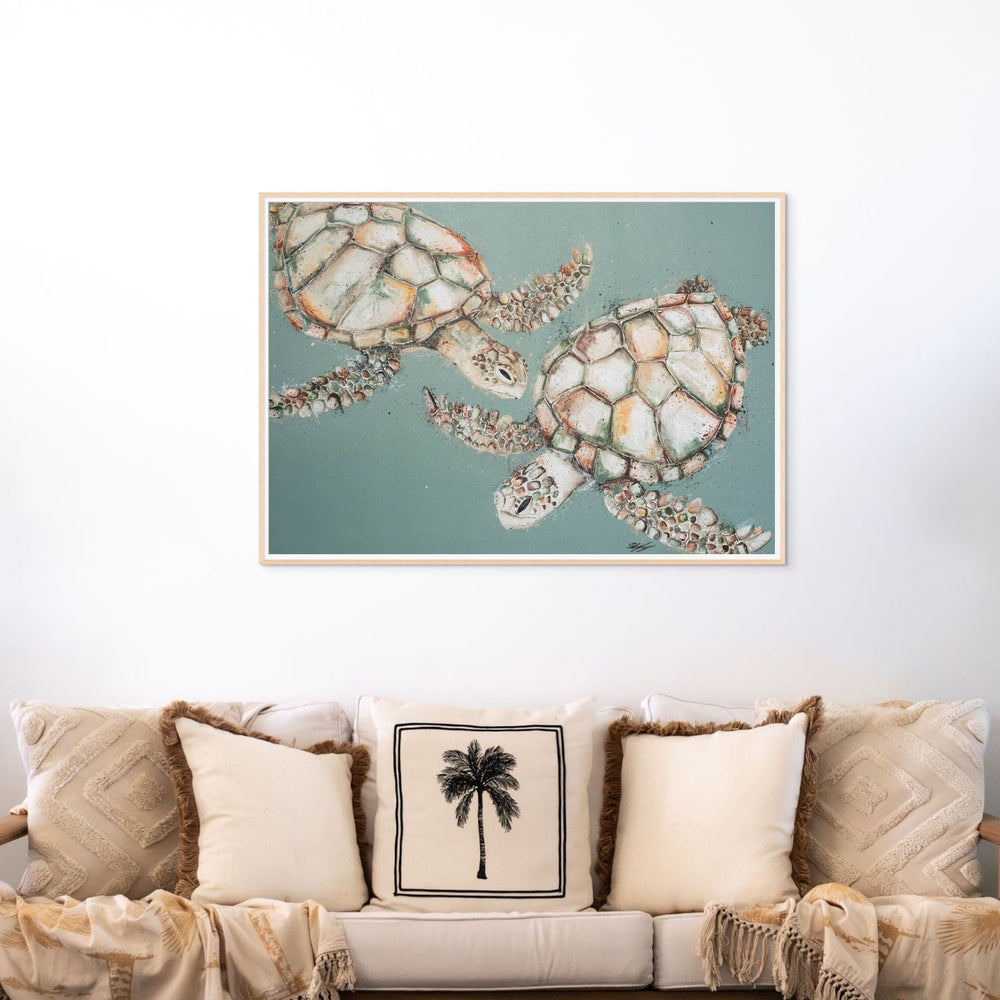 Two’s Company – sea turtle artwork on green background in bright white mat and light oak frame styled above sofa | Framed Paper Print
