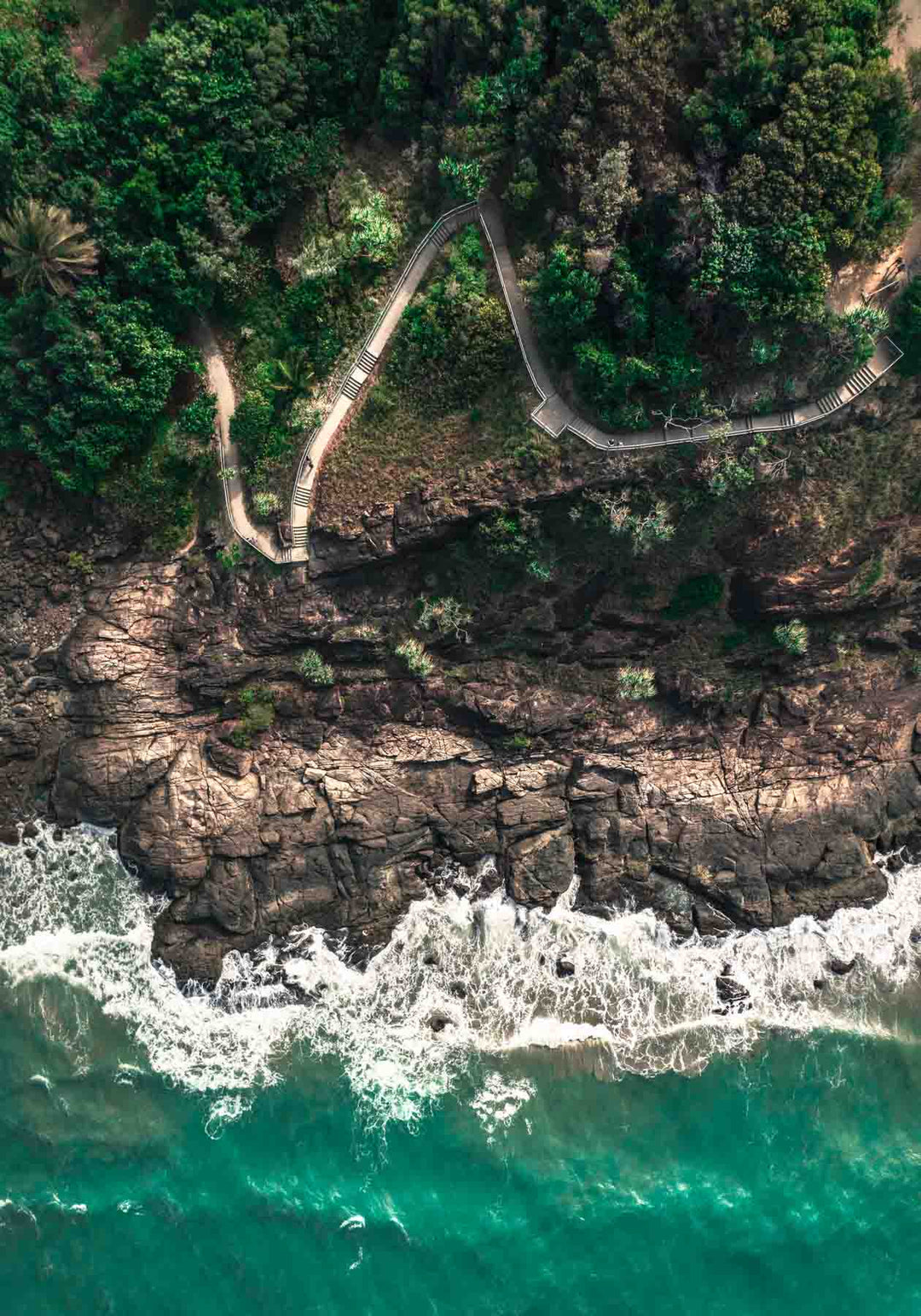 Up and Over – Top-down aerial view of Flagstaff Hill, Port Douglas at first light with pathway and breaking waves | Unframed Rolled Print by David Lloyd
