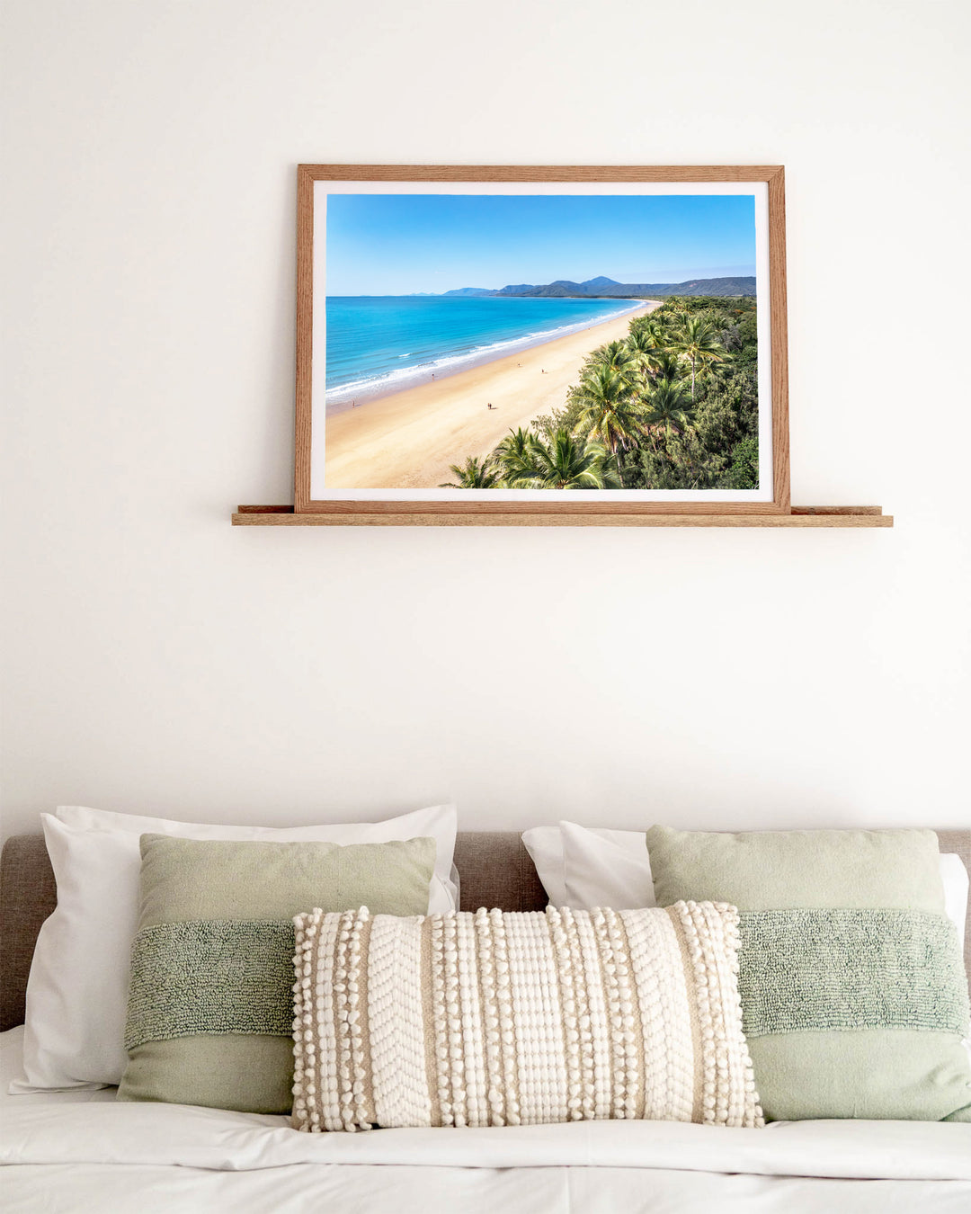 Walking the Miles – Four Mile Beach, Port Douglas, Aerial Photography by David Lloyd, framed paper print in oak frame, styled in a bedroom setting