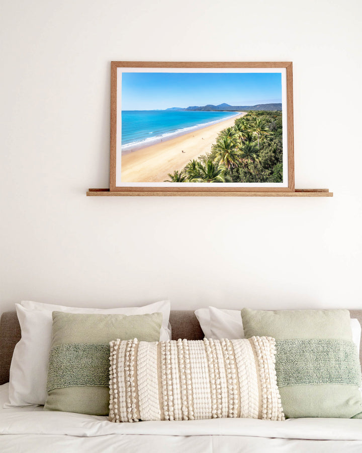 Walking the Miles – Four Mile Beach, Port Douglas, Aerial Photography by David Lloyd, framed paper print in oak frame, styled in a bedroom setting