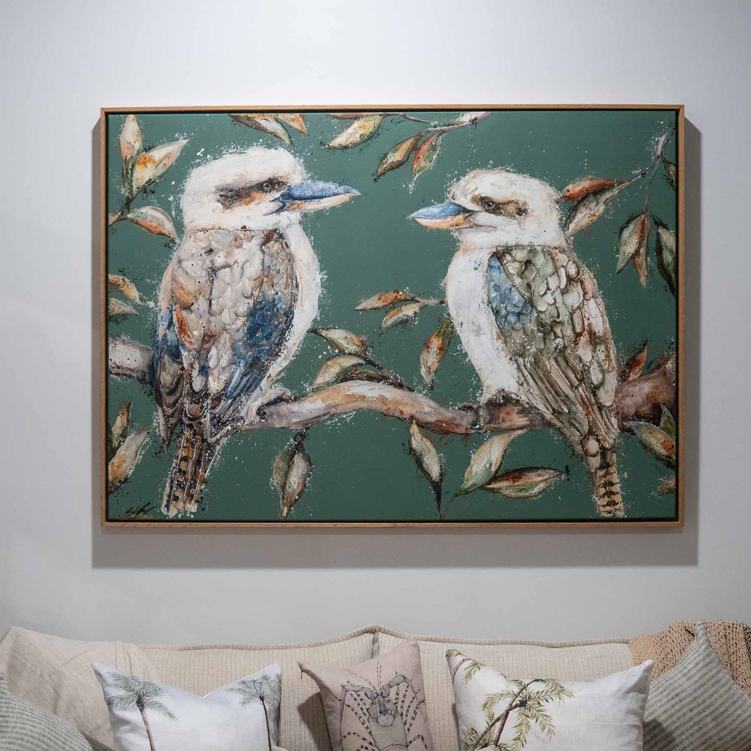 We Belong Together“ kookaburras art print hung above a comfortable couch in a home setting.