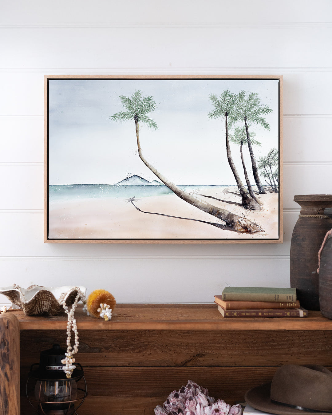 Where The Palm Trees Lead – Port Douglas beach and palm trees, framed canvas in oak float frame, styled above a timber console