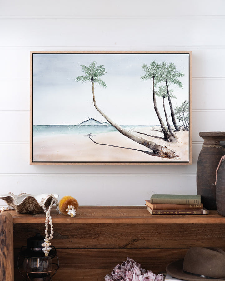 Where The Palm Trees Lead – Port Douglas beach and palm trees, framed canvas in oak float frame, styled above a timber console