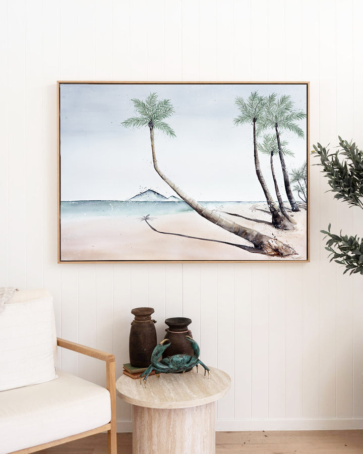 Where The Palm Trees Lead – Port Douglas beach and palm trees, framed canvas in oak float frame, styled in a living room