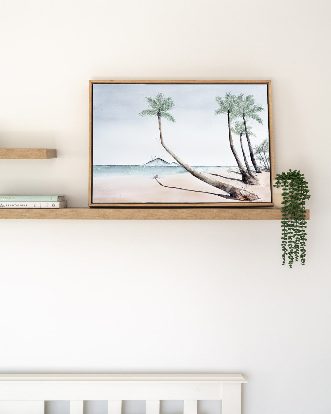Where The Palm Trees Lead – Port Douglas beach and palm trees, framed canvas in oak float frame, styled on a floating shelf