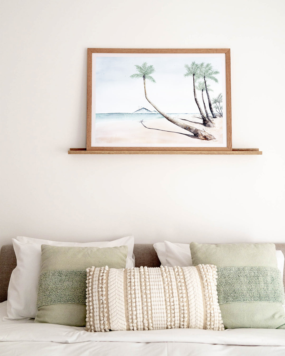 Where The Palm Trees Lead – Port Douglas beach and palm trees, framed paper print in oak frame, styled above a bed