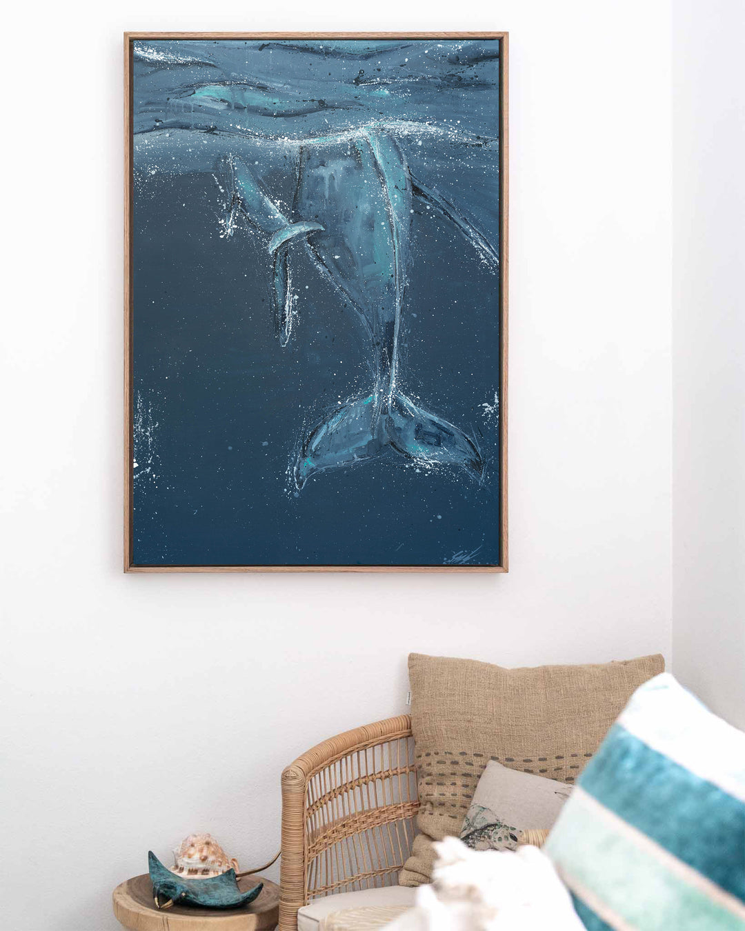 Wherever You Are – whale tails, framed canvas in oak float frame, styled in a coastal lounge
