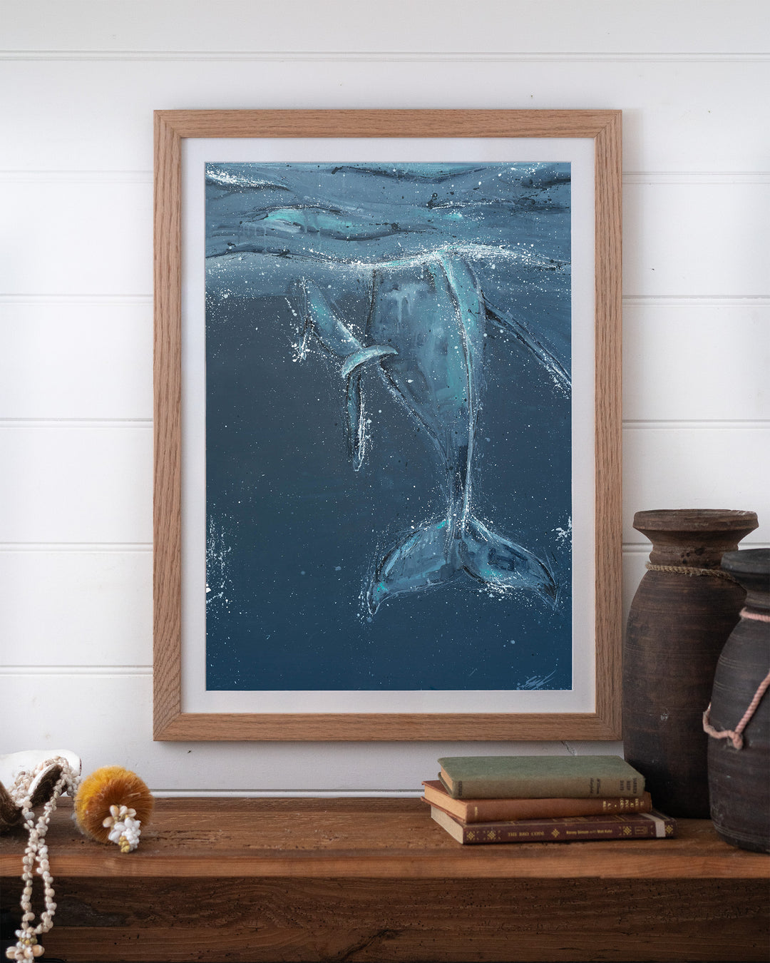 Wherever You Are – whale tails, framed paper print in oak frame, styled on a timber shelf