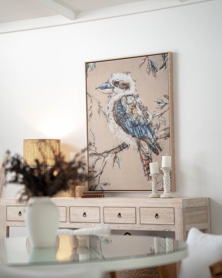 Whittaker | Kookaburra artwork by Stephanie Elizabeth hangs above a wood console in a cozy living room.