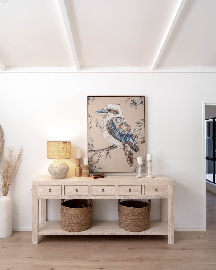 Wood console table with baskets, a lamp, candles, and Whittaker | Kookaburra artwork by Stephanie Elizabeth.