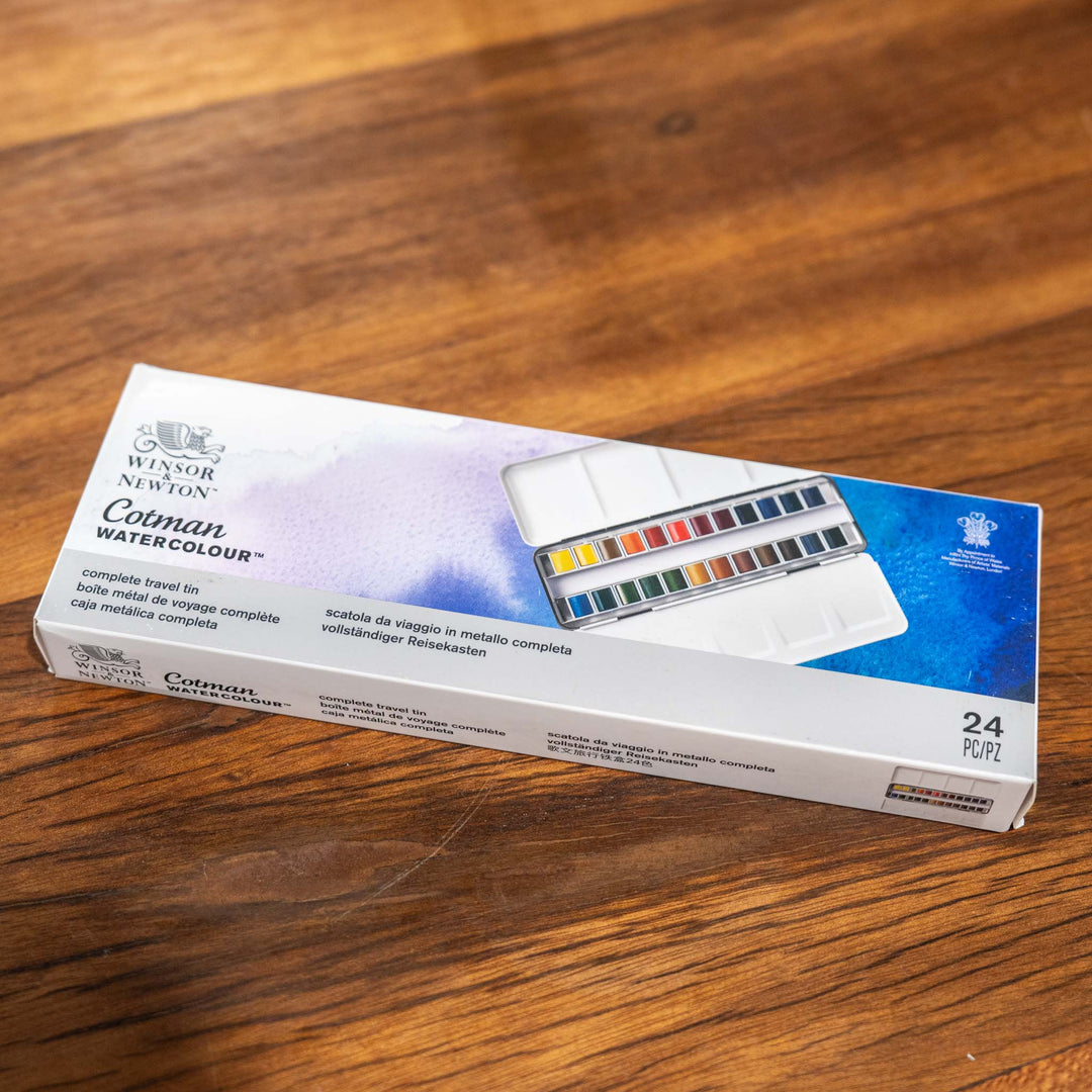 Windsor &amp; Newton 24 Piece Watercolour Set in a white box displayed on a wooden surface.