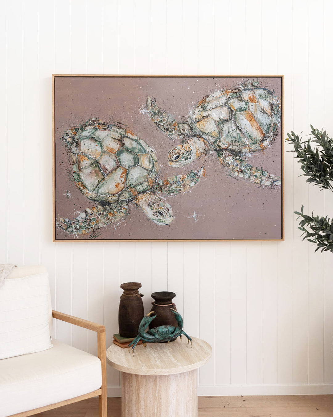 Winter Solstice – green sea turtles, framed canvas in oak float frame, styled in a living room