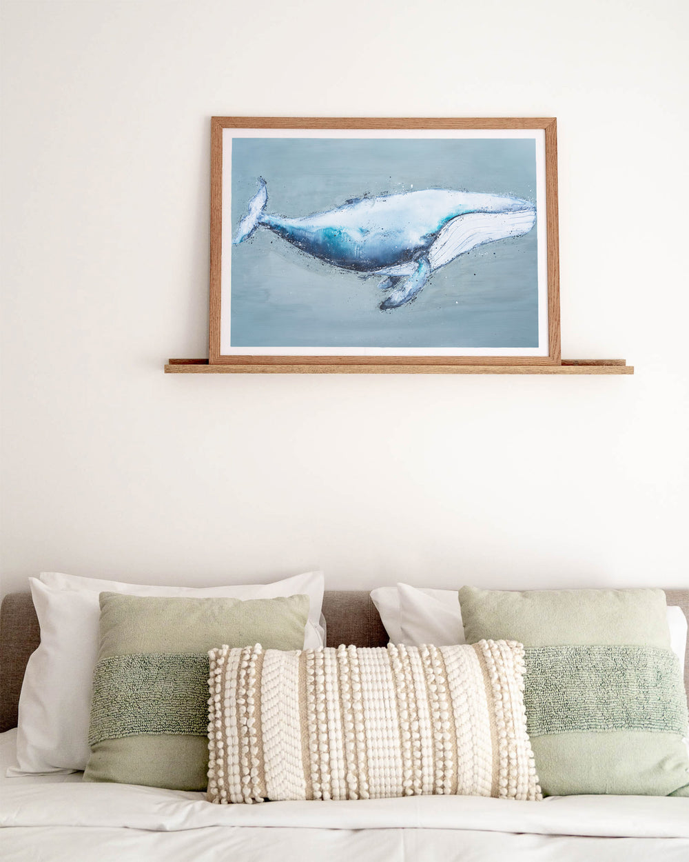 You're Gonna Go Far – humpback whale, framed paper print in oak frame, styled above a bed